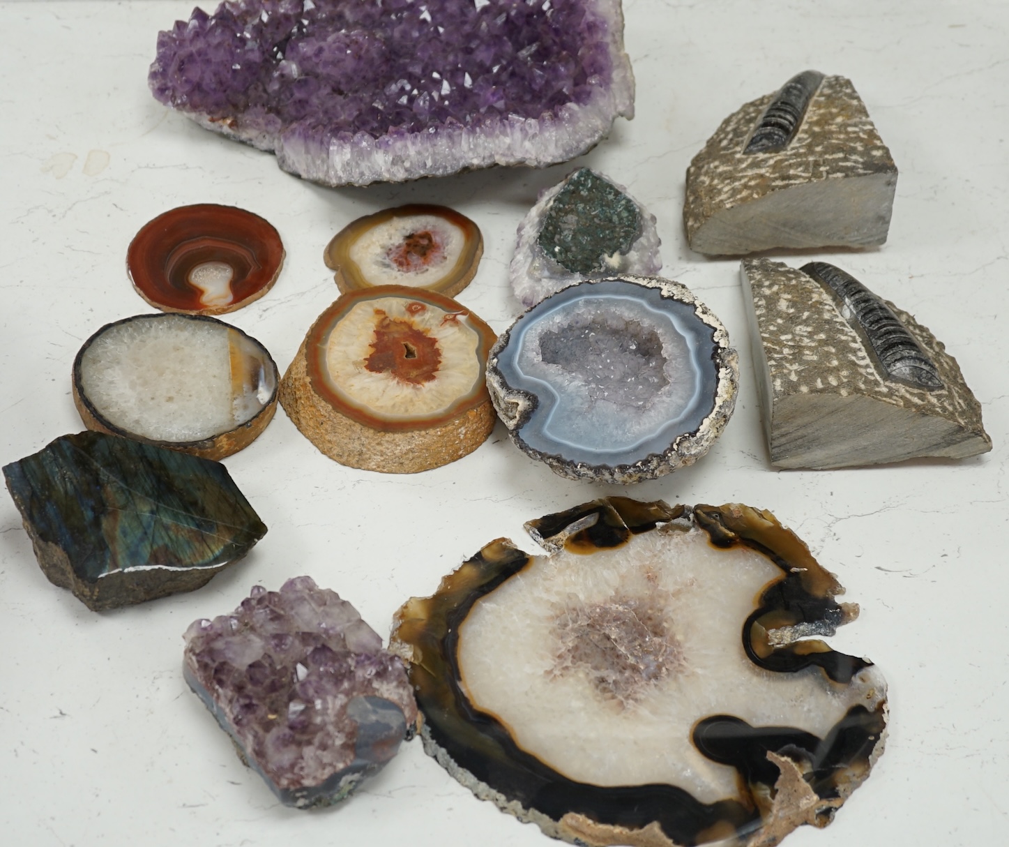 A group of mineral and fossil specimens, largest amethyst 26.5cm wide. Condition - good
